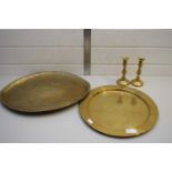 MIXED LOT COMPRISING TWO ISLAMIC BRASS TRAYS AND A PAIR OF CANDLESTICKS (4)