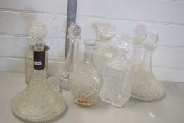 SEVEN VARIOUS ASSORTED CLEAR GLASS DECANTERS