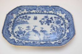 Two 18th century Qianlong period octagonal dishes decorated in blue and white with peacocks in a