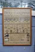 Victorian sampler decorated with rows of letters, numbers and religious text, along with stylised