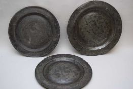 Three 18th century pewter circular plates or chargers, of plain form, 38cm diam