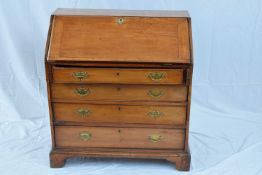 George III faded mahogany bureau with fall front opening to a shelved interior over four long