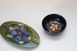 Small Moorcroft pin dish with floral design on blue ground together with a Hibiscus pattern