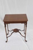 Edwardian mahogany two-tier occasional table, the rectangular top supported on elegant tapering legs