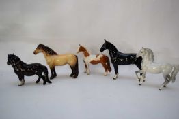 Group of Beswick horses including a prancing Palomino and a black Hackney horse (5)