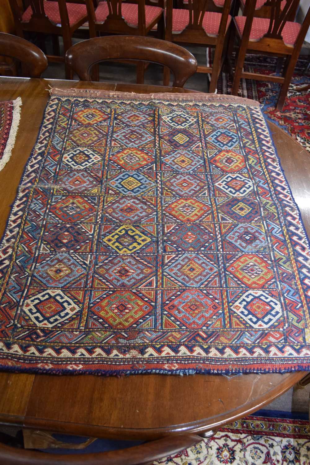 Middle Eastern saddlebag decorated with geometric design of lozenges on a principally red and blue