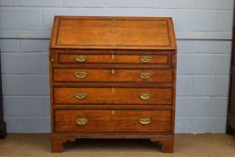 Large George III oak and mahogany cross banded bureau, the fall front opening to a fitted interior