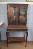 Edwardian mahogany side cabinet with moulded cornice over two glazed doors and base with two drawers