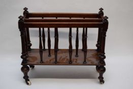 Small Victorian mahogany magazine rack with spindle turned supports and raised on brass and