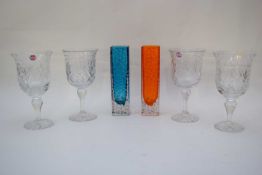 Group of four cut glass wine glasses, together with two small square shaped vases with stippled