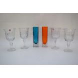 Group of four cut glass wine glasses, together with two small square shaped vases with stippled