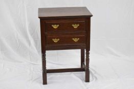 18th century style oak two-drawer side cabinet raised on turned legs, 56cm wide