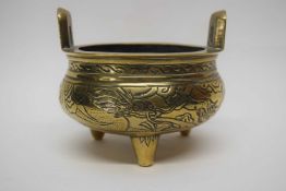 Small Chinese brass censer on three stub feet, 12cm diam