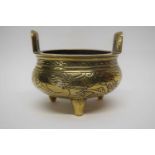 Small Chinese brass censer on three stub feet, 12cm diam