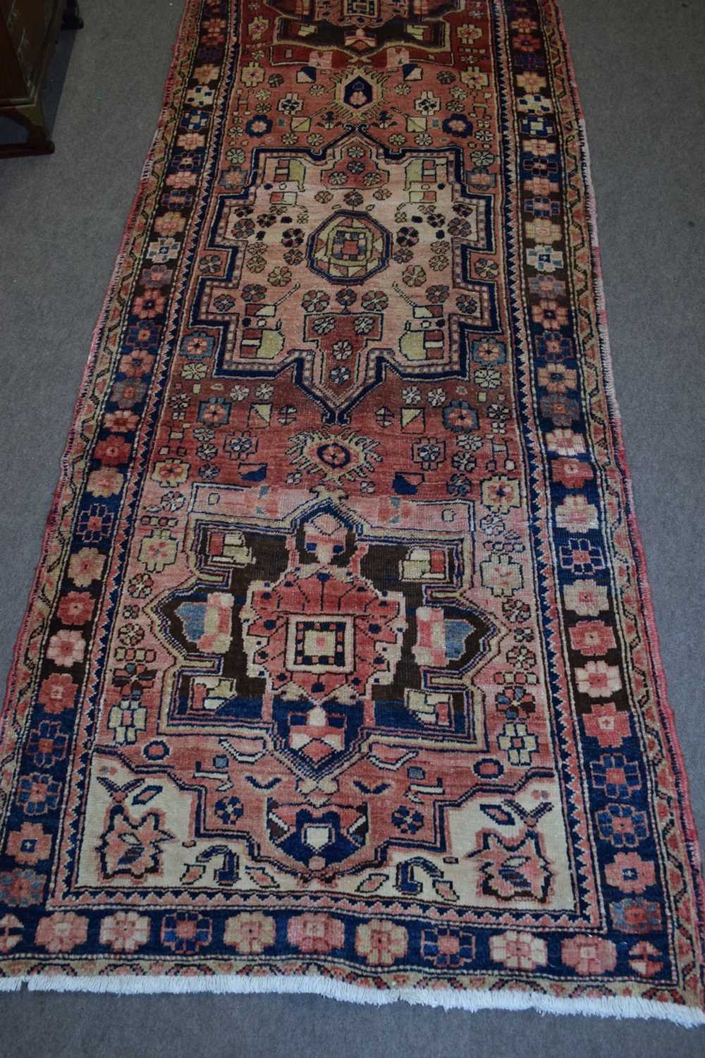 Karajeh runner carpet decorated with large medallions on a red background with geometric border - Image 4 of 4