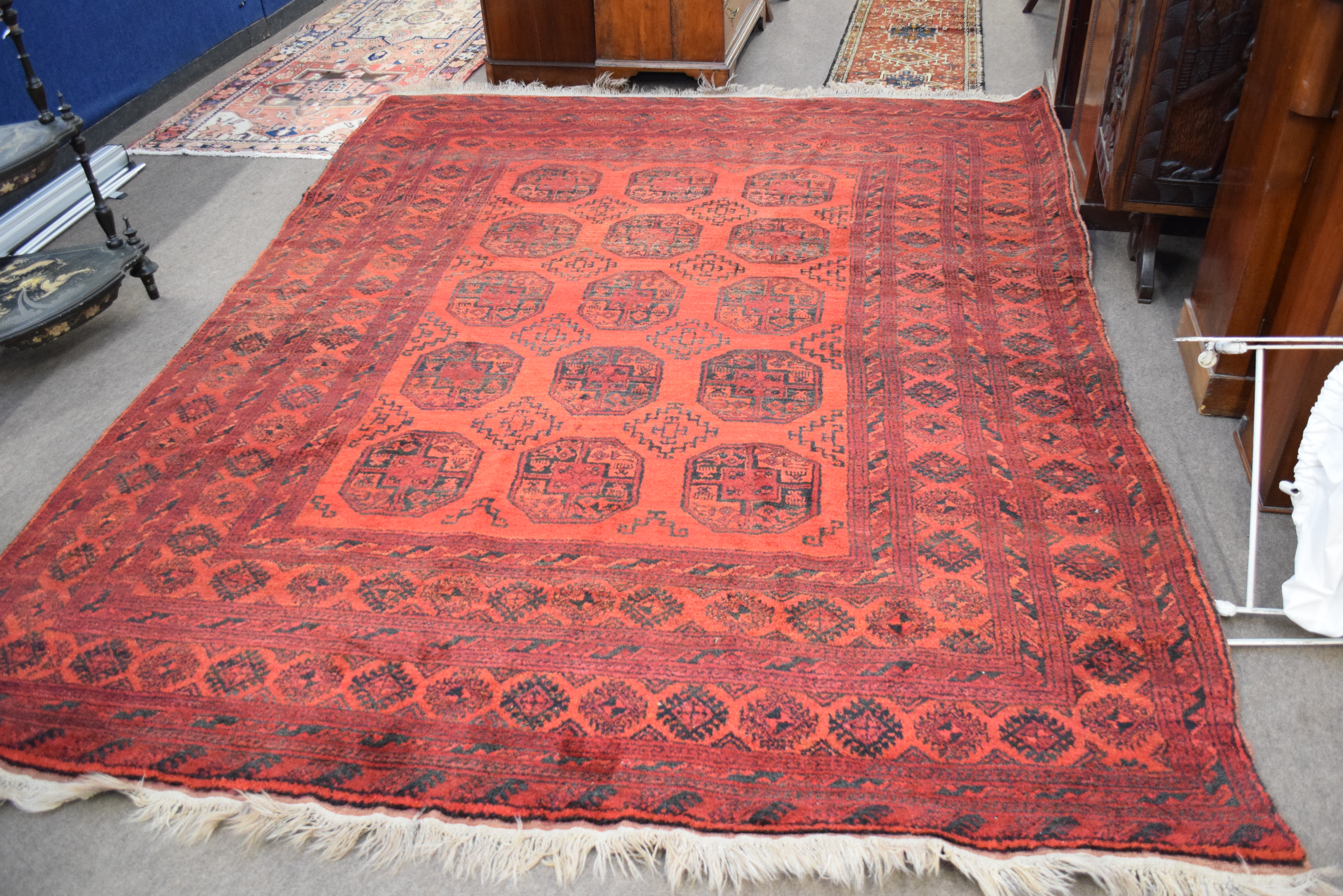 Large 20th century Bokhara type floor rug decorated with lozenges on a red background with a