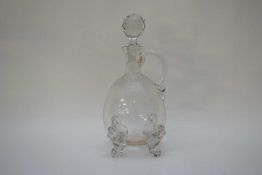 Glass carafe with moulded feet in the form of dogs heads with an engraved design of bees and flowers