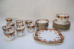 English porcelain tea set with a gilt and brown floral design comprising sandwich plate, side