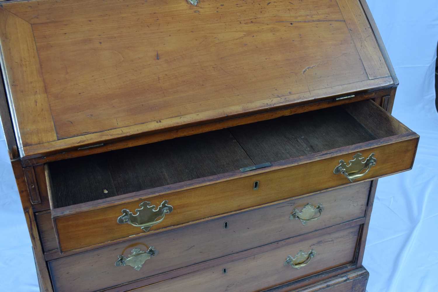 George III faded mahogany bureau with fall front opening to a shelved interior over four long - Image 4 of 7