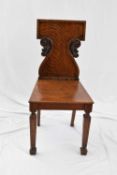 19th century oak hall chair with shaped and carved back, raised on tapering square front legs,