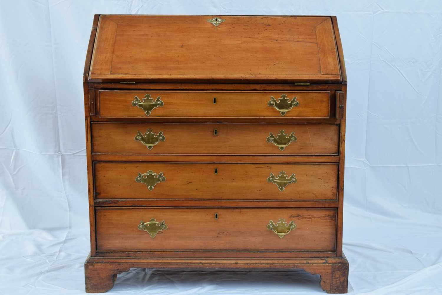 George III faded mahogany bureau with fall front opening to a shelved interior over four long - Image 3 of 7