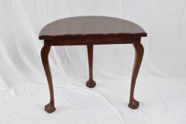 Edwardian mahogany demi-lune side table raised on three cabriole legs with ball and claw feet