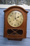 Early 20th century oak cased wall clock fitted with brass movement striking on a coiled gong, case