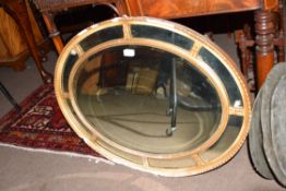 19th century oval wall mirror in gilt frame, 82cm wide (a/f)