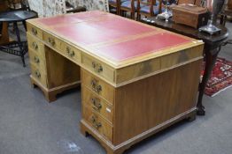 Reproduction twin pedestal partners desk, veneered in flame mahogany, the top with tooled red