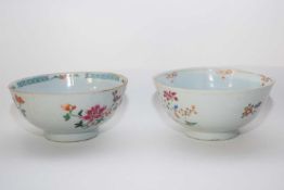 Two Qianlong period bowls with blue and white enamelled designs, mainly of flowers, some in