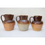 Quantity of three 19th century salt glaze jugs including a Kishere pottery example with riveted