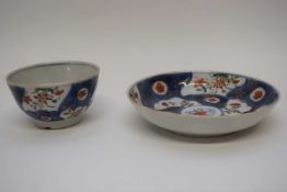 18th century Chinese porcelain tea bowl and saucer with a blue ground and gilt design with panels of