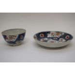 18th century Chinese porcelain tea bowl and saucer with a blue ground and gilt design with panels of