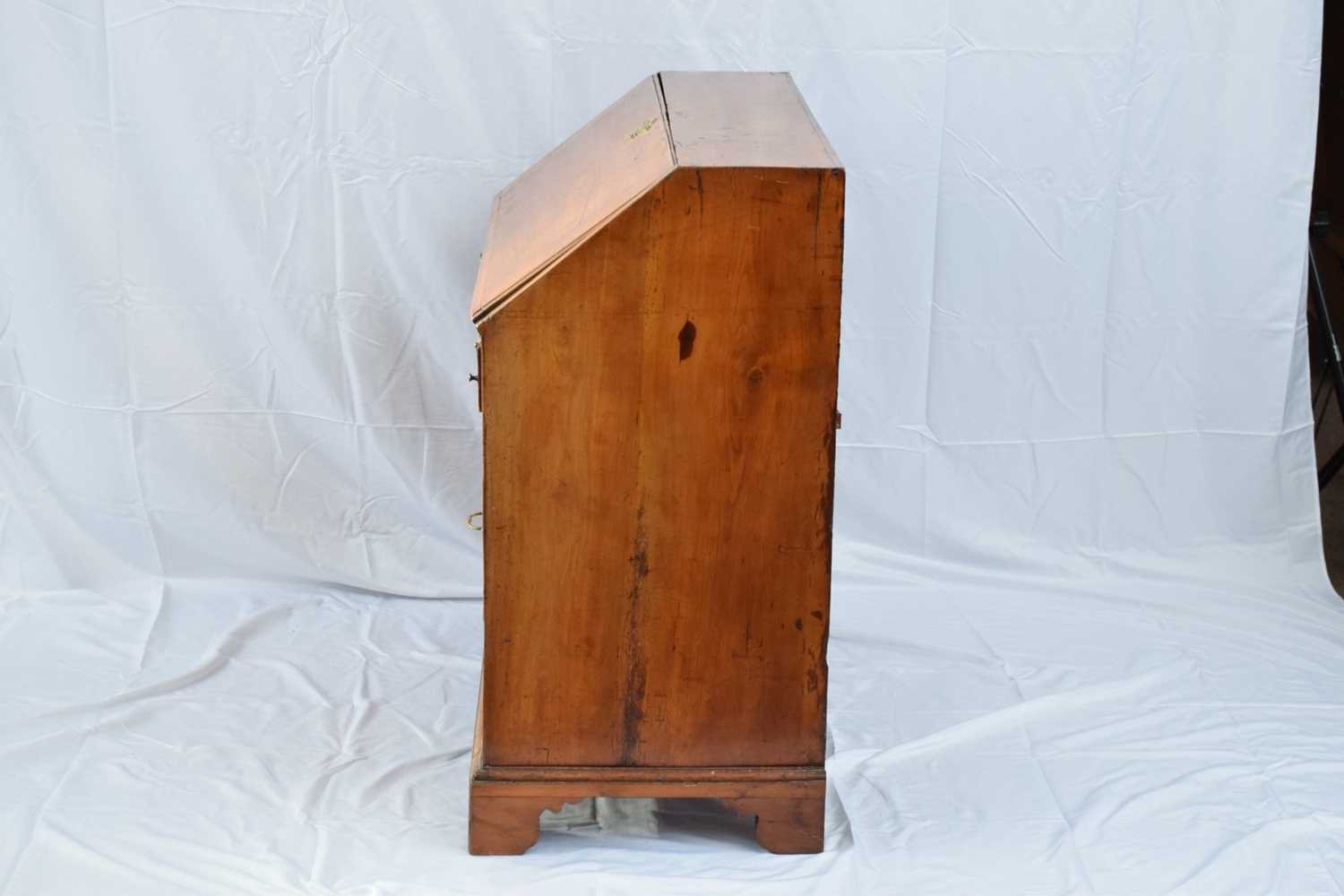 George III faded mahogany bureau with fall front opening to a shelved interior over four long - Image 2 of 7