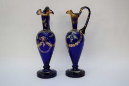 Pair of 19th century blue glass ewers with finely painted designs of acorns and flowers with central