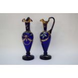 Pair of 19th century blue glass ewers with finely painted designs of acorns and flowers with central