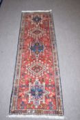 Small Karajeh runner carpet decorated with medallions on a red background, 175 x 60cm