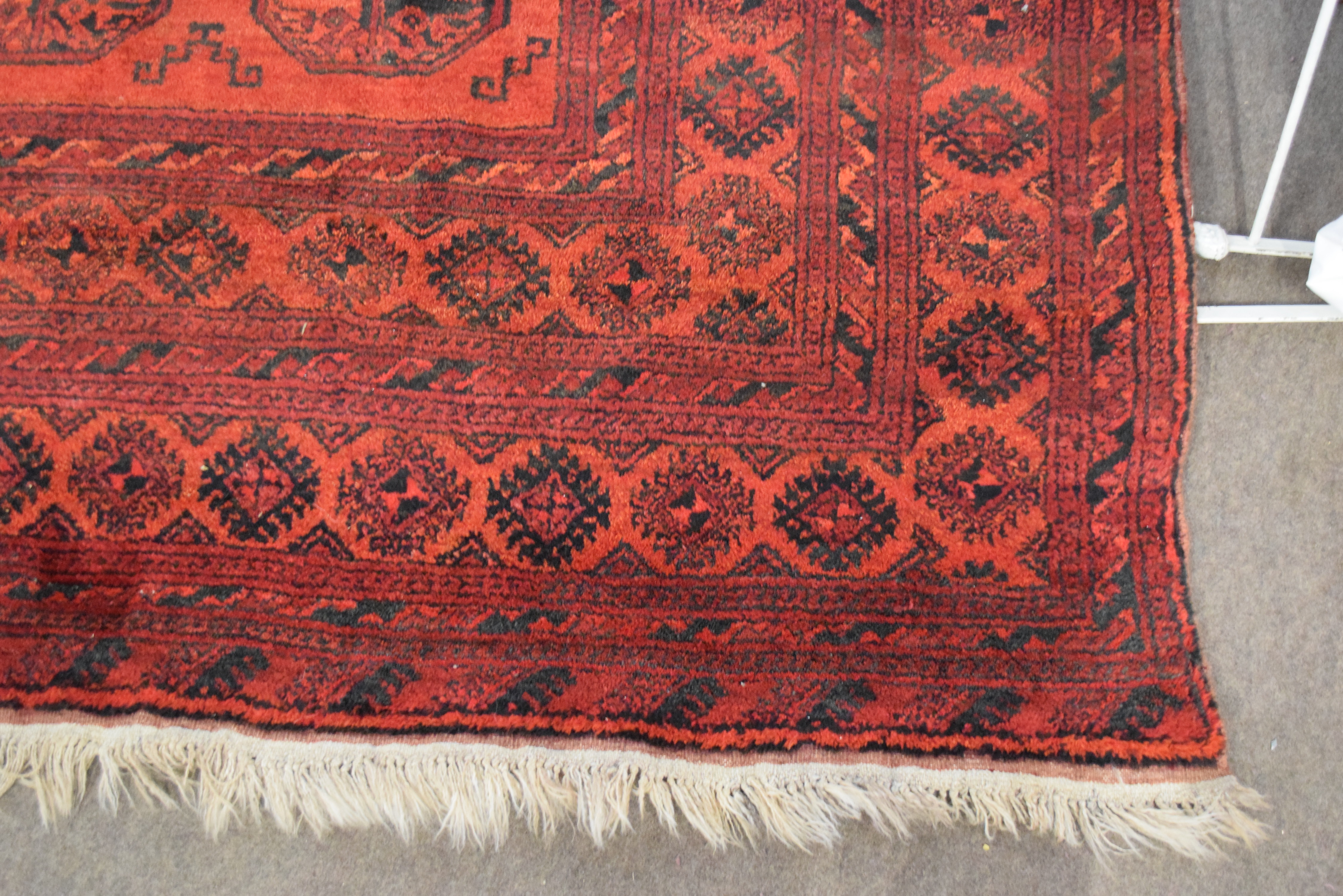 Large 20th century Bokhara type floor rug decorated with lozenges on a red background with a - Image 6 of 8