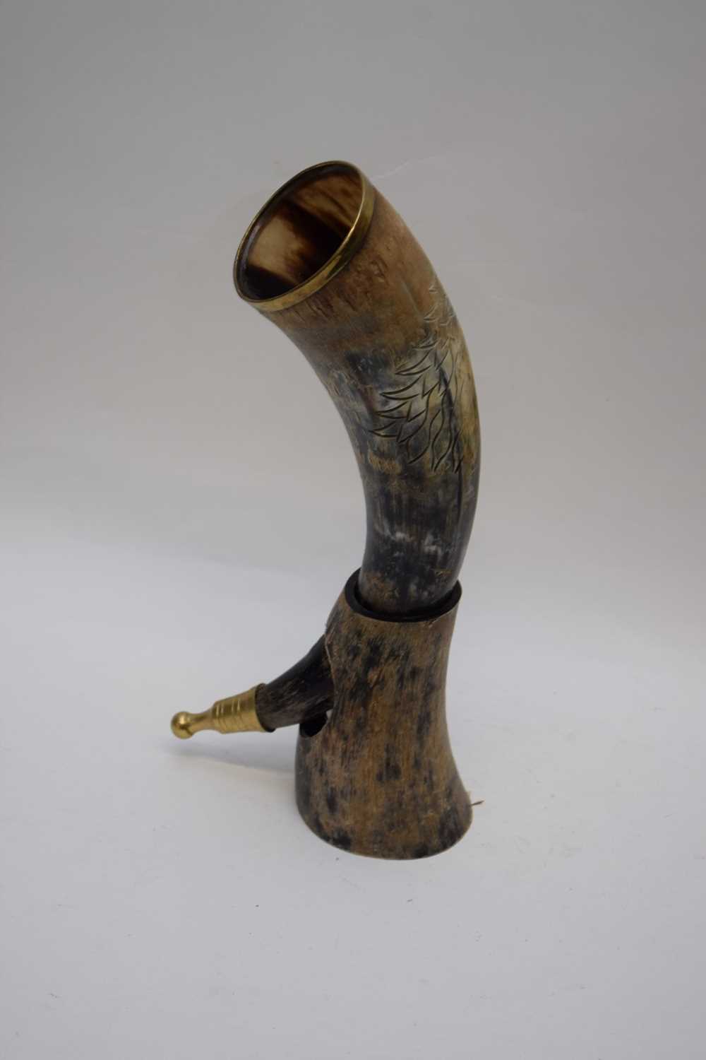 Antique brass mounted cow horn drinking vessel decorated with carved lions head detail, together