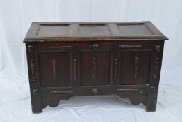 17th century oak coffer with three panelled top opening to a void interior, the front also with