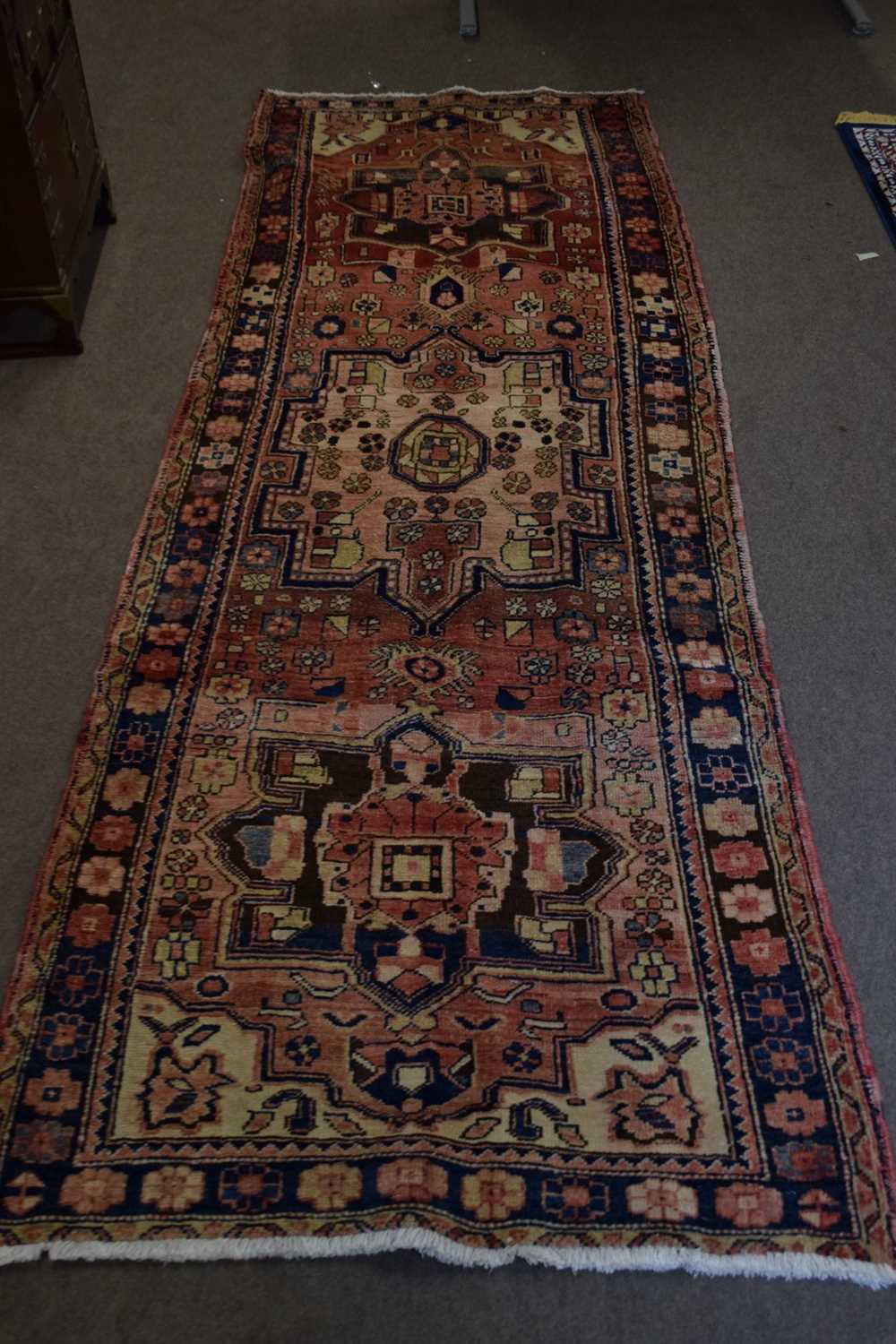Karajeh runner carpet decorated with large medallions on a red background with geometric border - Image 2 of 4