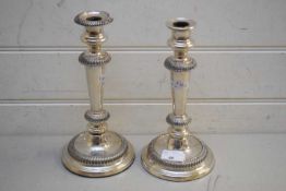 PAIR OF SHEFFIELD SILVER PLATE ON COPPER CANDLESTICKS OF CIRCULAR TAPERING FORM, ONE NOZZLE