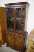 REPRODUCTION MAHOGANY ASTRAGAL GLAZED BOOKCASE CABINET WITH A BASE WITH TWO DOORS AND TWO DRAWERS,