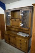 MODERN OAK LOUNGE DISPLAY CABINET WITH LEAD GLAZED TOP SECTION, CENTRAL DRINKS CABINET AND A BASE