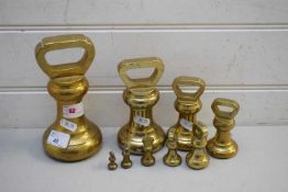 GRADUATED SET OF NINE VARIOUS BRASS BELL WEIGHTS