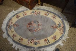 CHINESE OVAL WASHED WOOL RUG DECORATED WITH FLORAL PANELS, 135CM WIDE