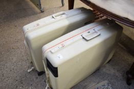 TWO WHITE HARD PLASTIC SUITCASES