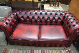 RED LEATHER CHESTERFIELD STYLE TWO-SEATER SOFA, APPROX 190CM WIDE