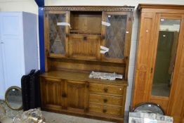 MODERN OAK LOUNGE DISPLAY CABINET WITH LEAD GLAZED TOP SECTION, CENTRAL DRINKS CABINET AND A BASE