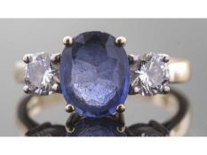 18ct gold sapphire and diamond three stone ring, the oval faceted sapphire 9.92 x 8.03 x 3.92mm,